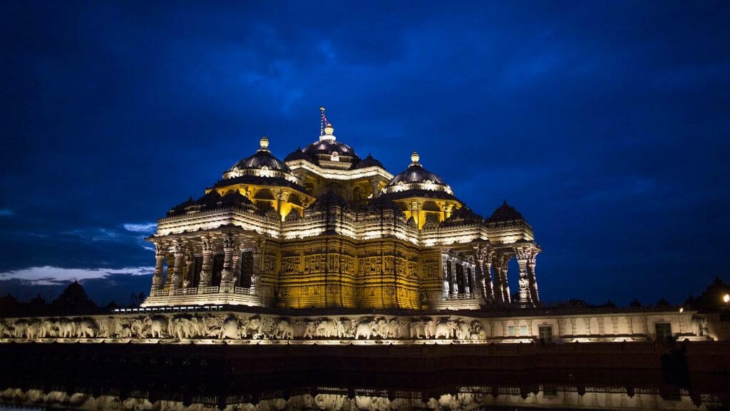 Akshardham Temple light up with a bit of light reflected off of a cloud in the distance