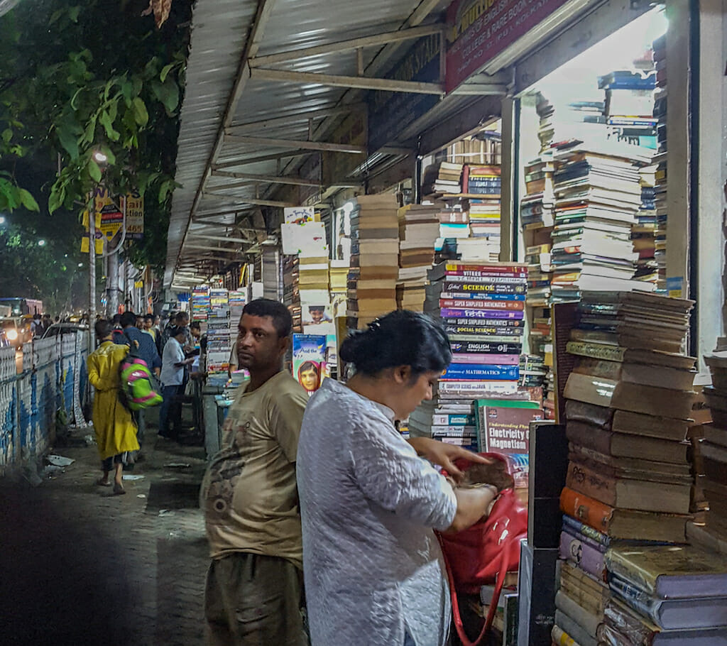 People scowering the booths filled with books at night