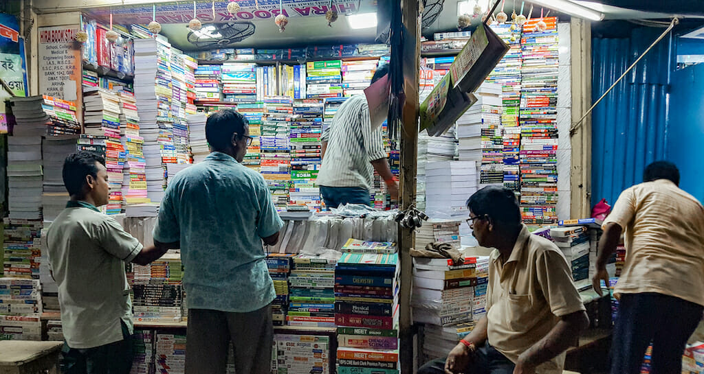 People look around a booth filled to the brim with books