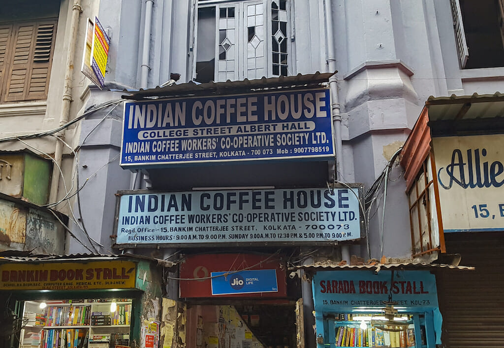 Indian coffee house sign in white letters against a blue back on top of an inverted sign